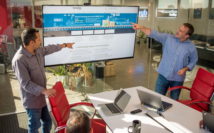 InMotion Hosting's Sunil Saxena leads a team meeting
