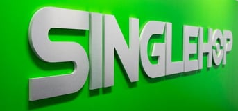 SingleHop's logo on a bright green wall
