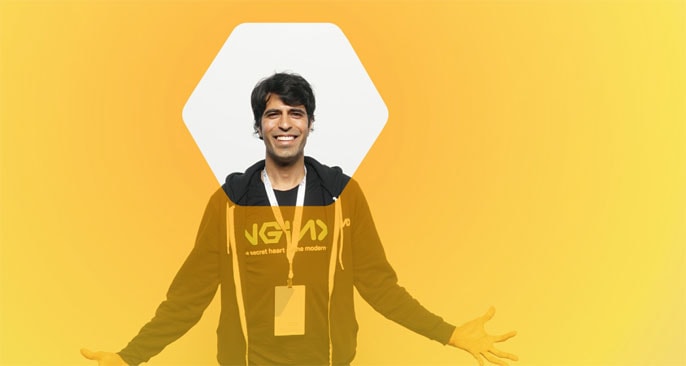 Faisal Memon, NGINX Technical Product Marketing Manager, stands behind a yellow screen