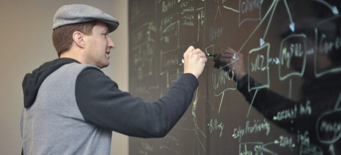 Image of Nathan Moore sketching out plans on a chalkboard Image of Nathan Moore sketching out plans on a chalkboard