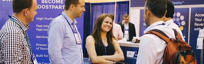 HostingCon attendees talk in exhibit hall