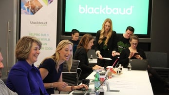 Photo of Blackbaud employees in a board room