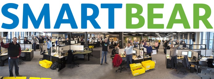 SmartBear logo with panoramic image of team and office SmartBear logo with panoramic image of team and office
