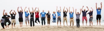 Image of Pagely team jumping on the beach