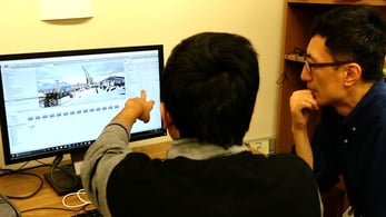 Charlie Hu and graduate student working on Furion