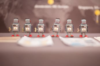Photo of a team of windup robots with FastComet logos on their chasis