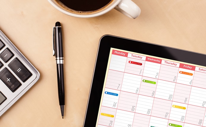 Image of calendar with calculator and coffee Image of calendar with calculator and coffee