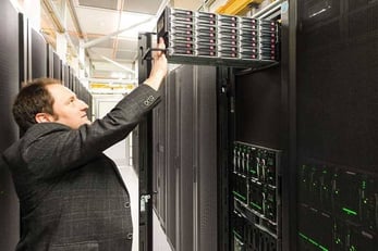 Photo of Eric Hulbert inspecting a server in Opus Interactive's Hillsboro datacenter
