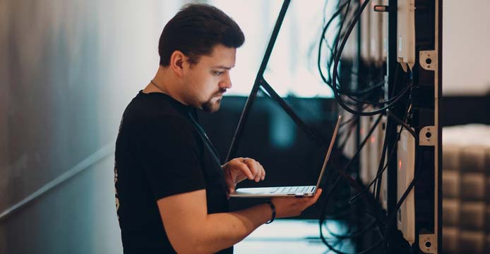 Image of employee working on a server Image of employee working on a server