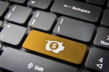 Photo of a computer keyboard with a piggy bank symbol on the enter key Photo of a computer keyboard with a piggy bank symbol on the enter key