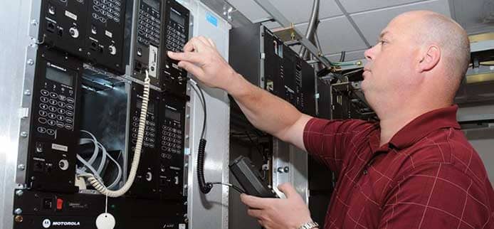 Image of a person working on a server Image of a person working on a server