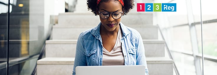 A photo of a woman on a laptop