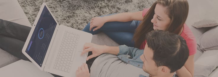 Image of a couple looking at laptop with IObit software Image of a couple looking at laptop with IObit software