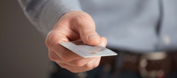 Image of a man handing over a credit card