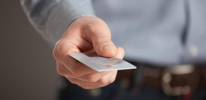 Hand holding a credit card for payment Hand holding a credit card for payment