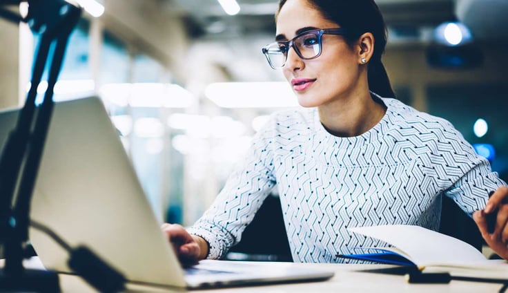 Image of woman sitting at a laptop