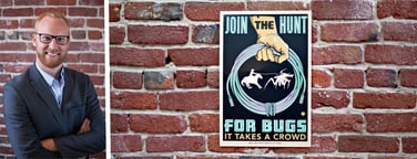 Photo of Casey Ellis and a Bugcrowd poster on a brick wall