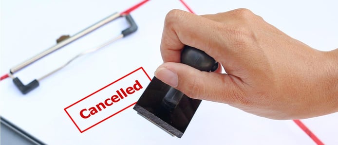 Image of a hand stamping a cancellation on a fom
