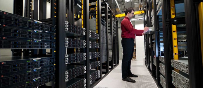 Image of server administrator working in a datacenter Image of server administrator working in a datacenter