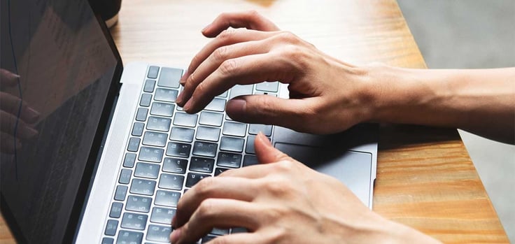 Image of hands typing on a laptop Image of hands typing on a laptop