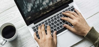 Image of someone typing on a laptop