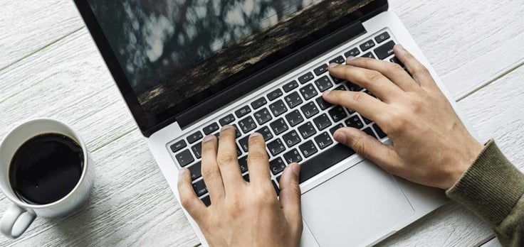 Image of someone typing on a laptop Image of someone typing on a laptop