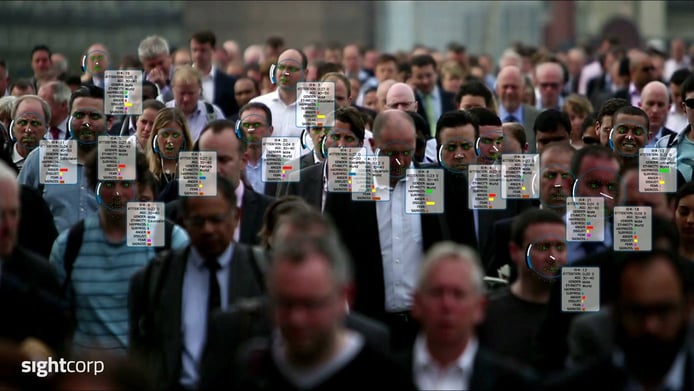 A crowd with data bubbles over each person's head A crowd with data bubbles over each person's head