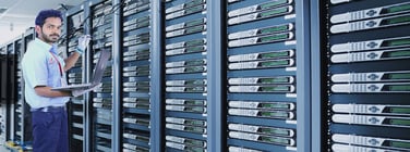 Man with servers in datacenter Man with servers in datacenter