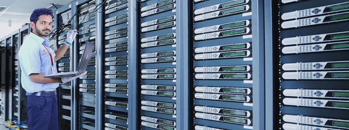 Man with servers in datacenter Man with servers in datacenter