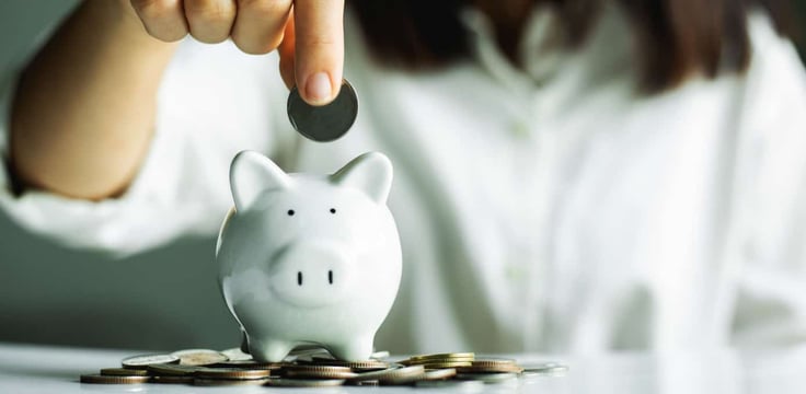 Putting coins in a piggy bank