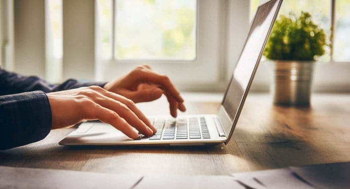 Person typing on a laptop Person typing on a laptop
