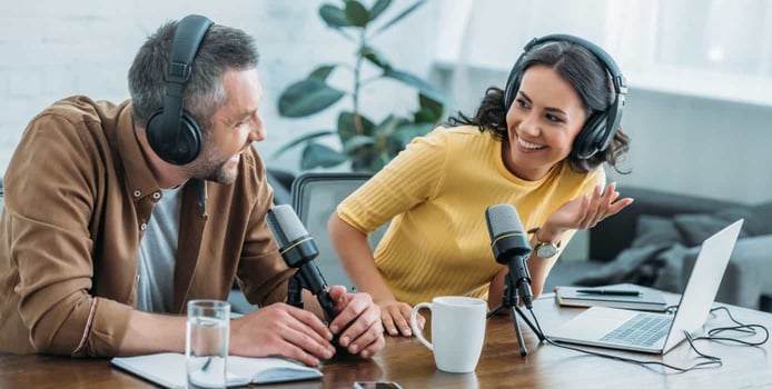 man and woman hosting a podcast