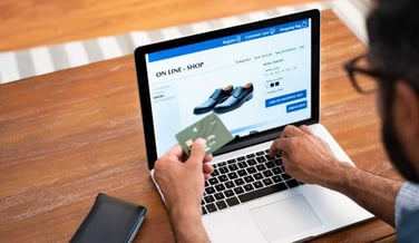 Man using credit card to do shopping online with laptop. Mature man buying formal shoes online. Man making online payment with credit card and laptop.