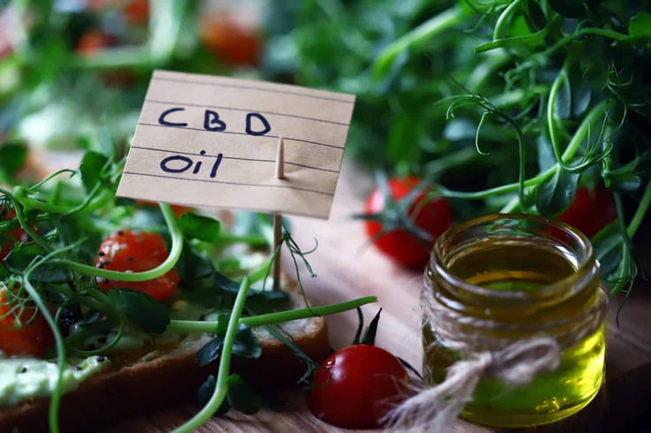 Toast with a "CBD oil" note pinned via toothpick Toast with a "CBD oil" note pinned via toothpick