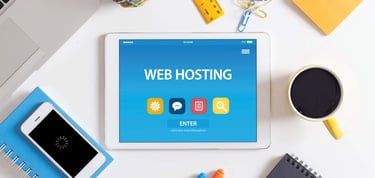 web hosting icons and items sitting on a desk
