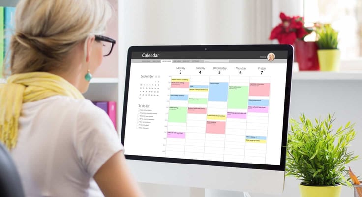 Woman using calendar desktop app Woman using calendar desktop app