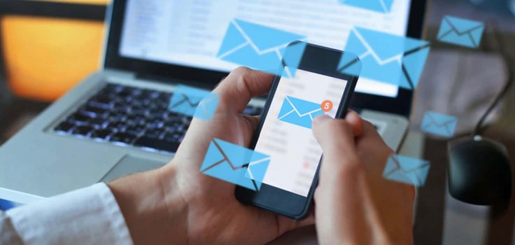 Person sending emails from their phone Person sending emails from their phone