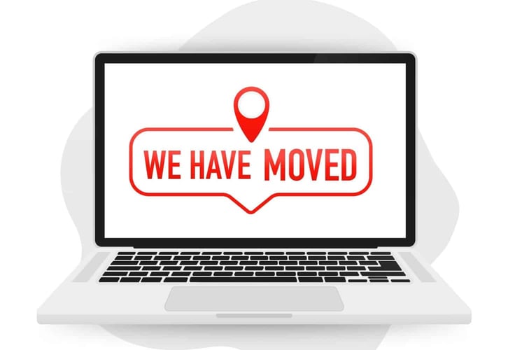 A laptop with a screen that reads "We have moved."