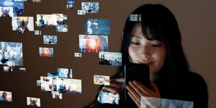 Woman looking at a phone with many screens Woman looking at a phone with many screens
