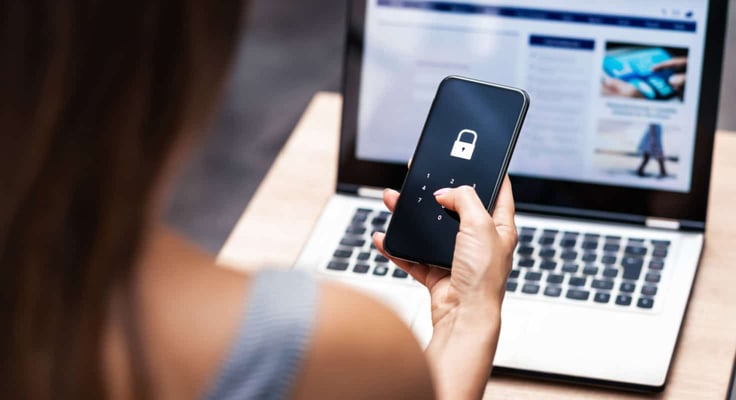 Woman holding an iPhone with a lock on the screen Woman holding an iPhone with a lock on the screen