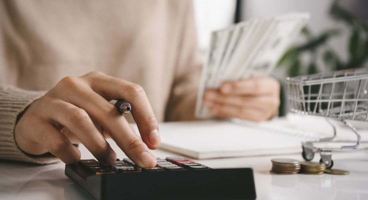 A person budgeting at a desk A person budgeting at a desk