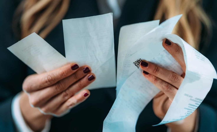 A woman looking at receipts