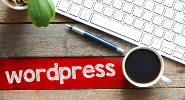 WordPress with coffee mug, keyboard, and pen