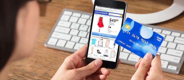 Person using a credit card to make online purchase