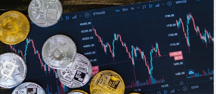 Picture of stylized coins next to stock tracker for Ethereum blockchain.