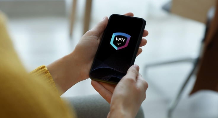 Woman using smartphone with switched on VPN indoors, closeup