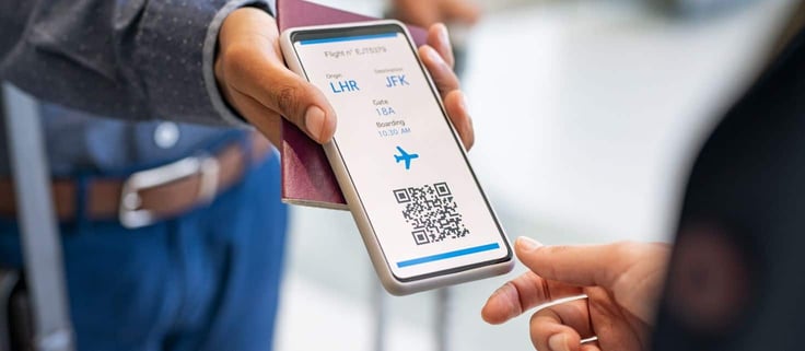 A person presenting an airline ticket on their phone to a gate agent.