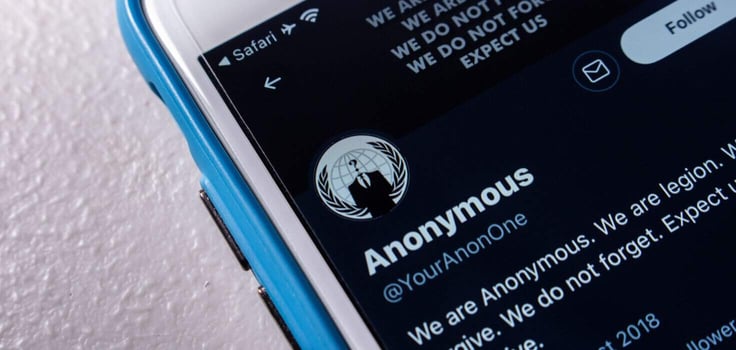Twitter account of Anonymous, a decentralized international activist and hacktivist collective, on an iPhone screen