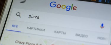 Generic smartphone screen close up with google search application. Macro shot of search query for pizza delivery. Abstract internet services background