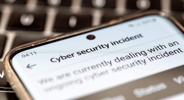 Close up of a message on a mobile phone from a company informing its clients of an ongoing cyber security incident. Close up of a message on a mobile phone from a company informing its clients of an ongoing cyber security incident.